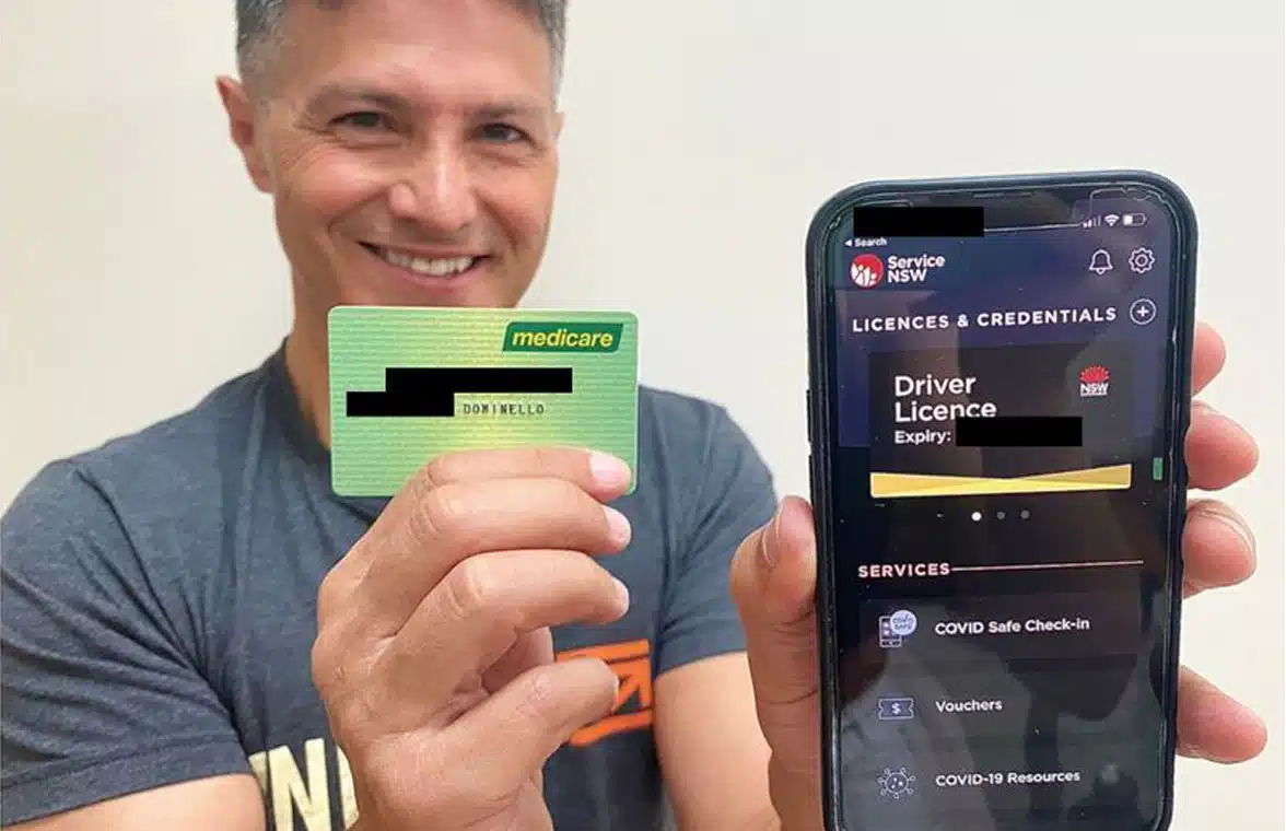 Victor Dominello showing New South Wales digital driving licence on smartphone
