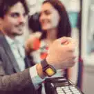Man using his smartwatch to make in-store wearable payment in Italy
