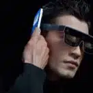 Man wearing Discovery Edition of Xiaomi’s Wireless AR Glass wearable device and pairing via NFC