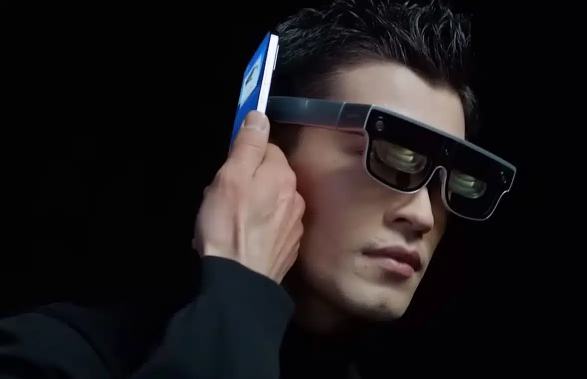 Man wearing Discovery Edition of Xiaomi’s Wireless AR Glass wearable device  and pairing via NFC