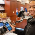 University of Florida contactless mobile ID on smartphone held by student
