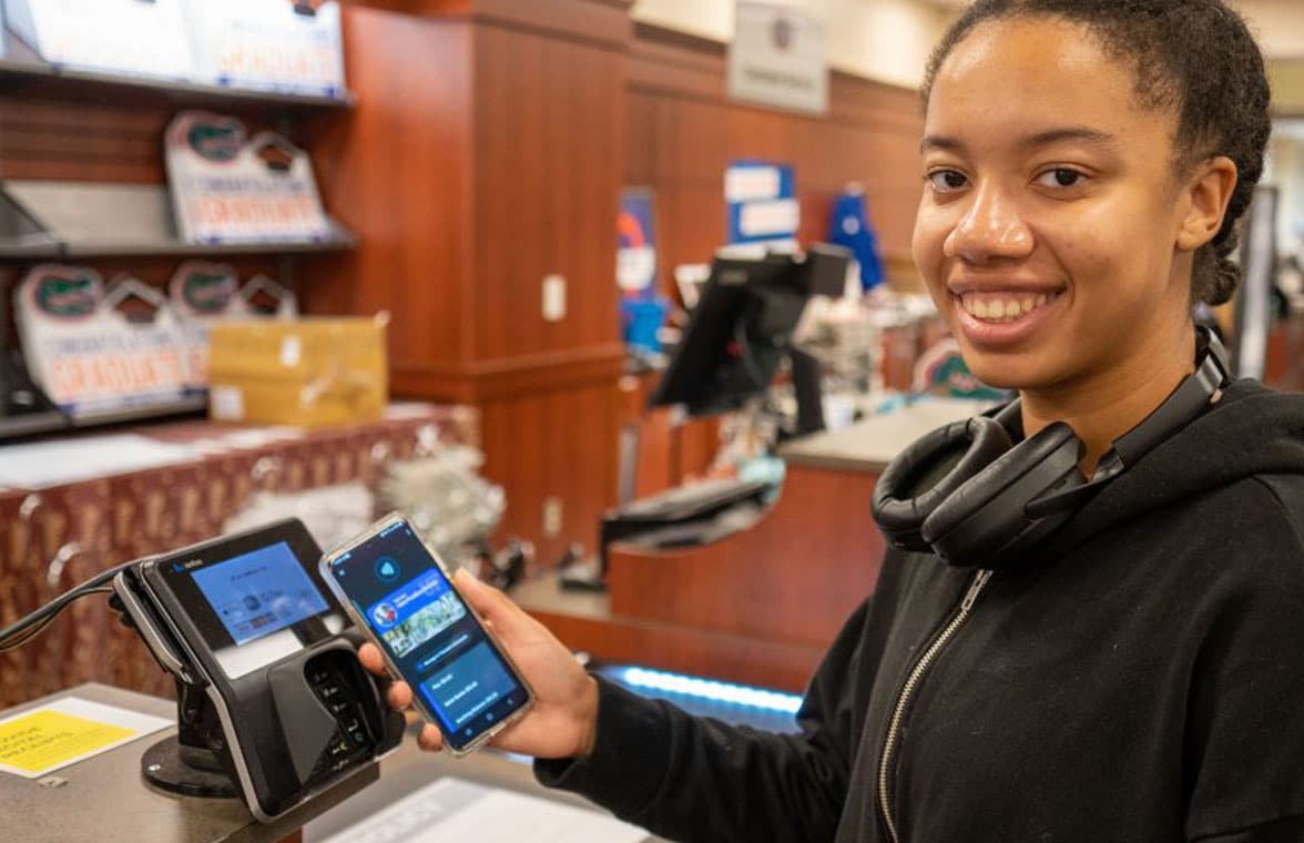 University of Florida contactless mobile ID on smartphone held by 
student