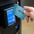 Person making contactless payment at a vending machine in the USA