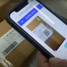 Qr code on a parcel being scanned as part of the EU open source product authentication platform supply chain tracking project