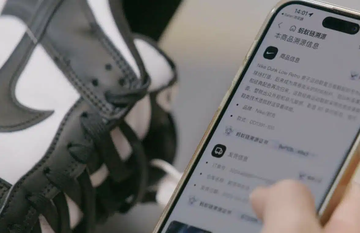 Nike sneakers with NFC chips plus hand holding a smartphone