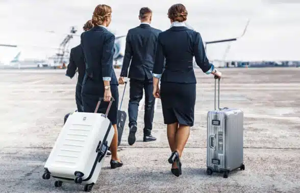 Air crew with luggage that uses Bagtag reusable NFC bag tags for contactless check-in