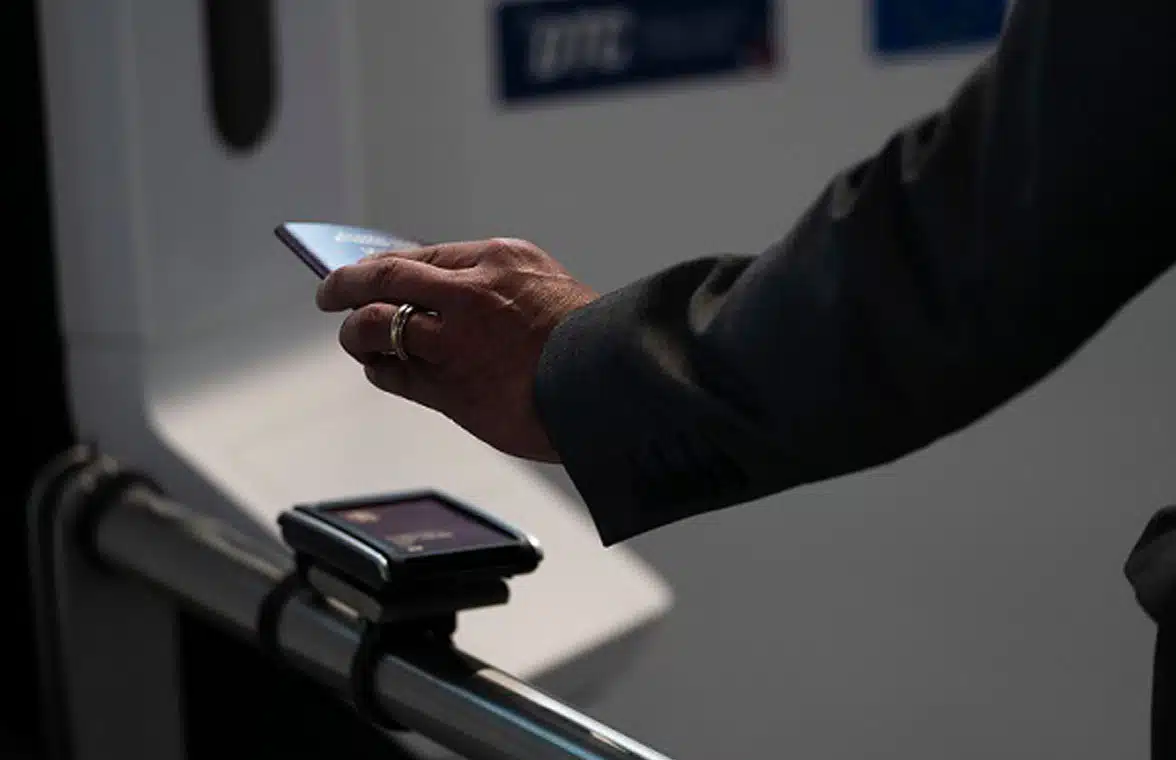 Person tapping their phone containing digital passport on a reader in finland