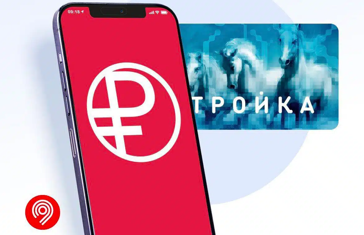 Digital ruble symbol on a smartphone with Troika card in the background
