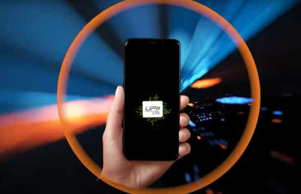 Hand holding a smartphone with UPI lite logo with an orange circle around the whole image