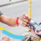 Customer using Bancolombia visa debit card on his watch to make a contactless NFC payment via Google Wallet
