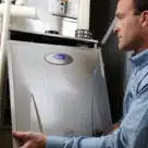 Man installing HVAC system with NFC diagnostics