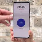 Person making contactless donation on Android phone via Give a little Charity app