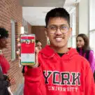 Student holding York University Yu-card mobile student ID